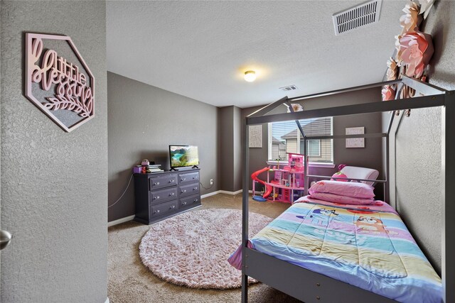 carpeted bedroom with visible vents, a textured ceiling, a textured wall, and baseboards