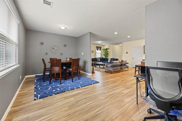 dining space featuring baseboards, visible vents, and wood finished floors