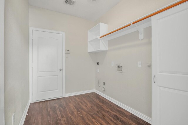 laundry room featuring laundry area, hookup for a gas dryer, baseboards, dark wood-type flooring, and visible vents