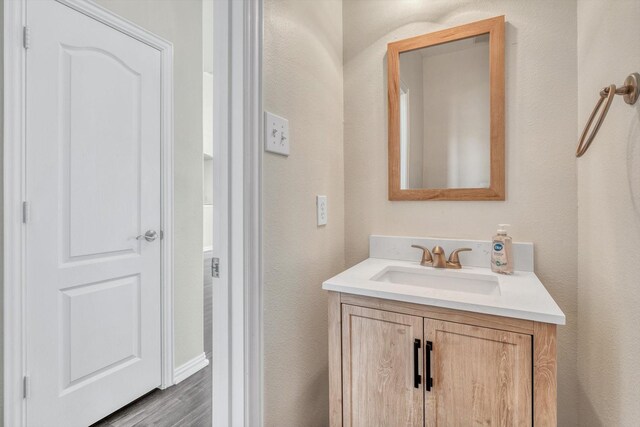 bathroom featuring vanity and wood finished floors