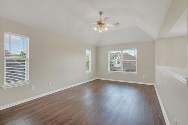 unfurnished room with baseboards, a ceiling fan, dark wood-style flooring, and visible vents