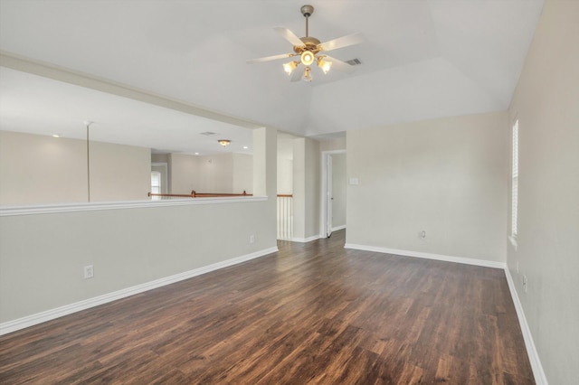 unfurnished living room featuring baseboards, ceiling fan, vaulted ceiling, and dark wood-style flooring