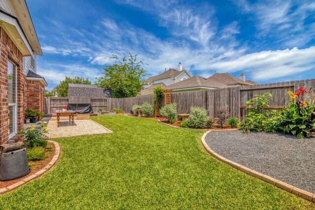 view of yard with a patio and a fenced backyard