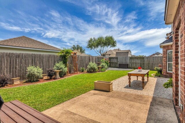 view of yard with a fenced backyard and a patio