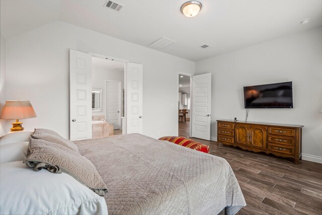 bedroom featuring baseboards, visible vents, dark wood-style floors, and lofted ceiling