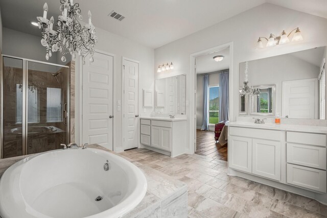 full bath featuring an inviting chandelier, a stall shower, a bath, and visible vents