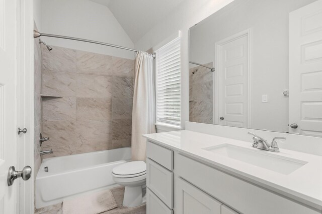 full bath featuring tile patterned flooring, vaulted ceiling, shower / bath combo, vanity, and toilet