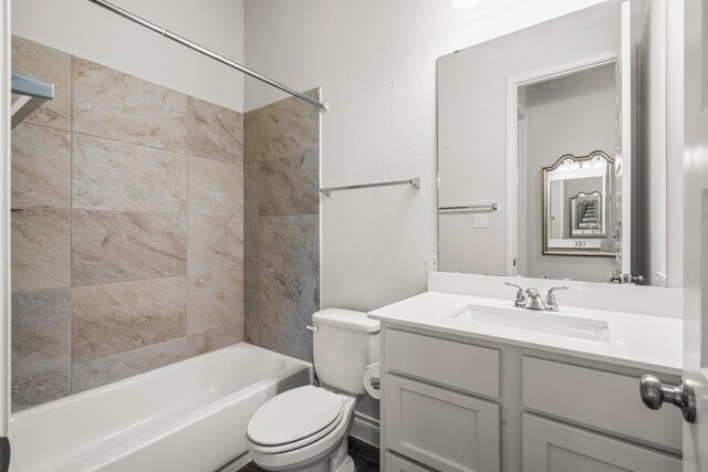 bathroom featuring toilet, shower / tub combination, and vanity