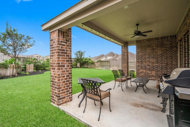 view of patio with area for grilling, a ceiling fan, and a fenced backyard