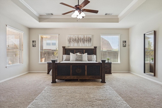 2411 Lakeway Dr, Friendswood, TX 77546 - carpeted bedroom with ornamental molding, a tray ceiling, and visible vents