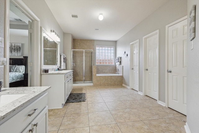 2411 Lakeway Dr, Friendswood, TX 77546 - ensuite bathroom featuring visible vents, a garden tub, two vanities, and a shower stall