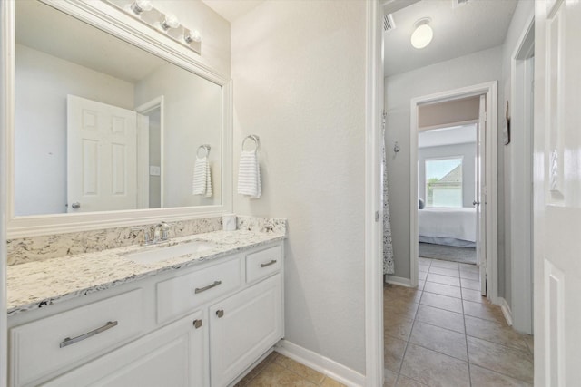 2411 Lakeway Dr, Friendswood, TX 77546 - ensuite bathroom with vanity, baseboards, ensuite bath, and tile patterned flooring