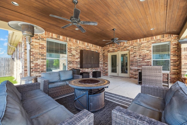 2411 Lakeway Dr, Friendswood, TX 77546 - view of patio with ceiling fan, fence, french doors, and an outdoor living space with a fire pit