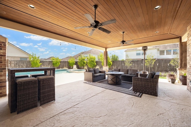 2411 Lakeway Dr, Friendswood, TX 77546 - view of patio with a fenced backyard, an outdoor living space with a fire pit, a pool with connected hot tub, and ceiling fan
