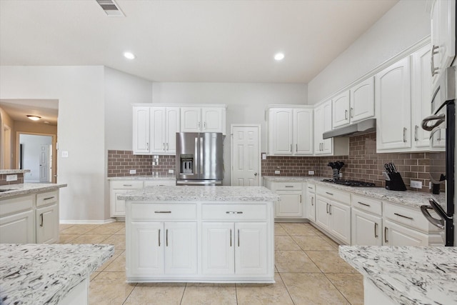 2411 Lakeway Dr, Friendswood, TX 77546 - kitchen featuring white cabinets, light tile patterned floors, tasteful backsplash, and stainless steel appliances