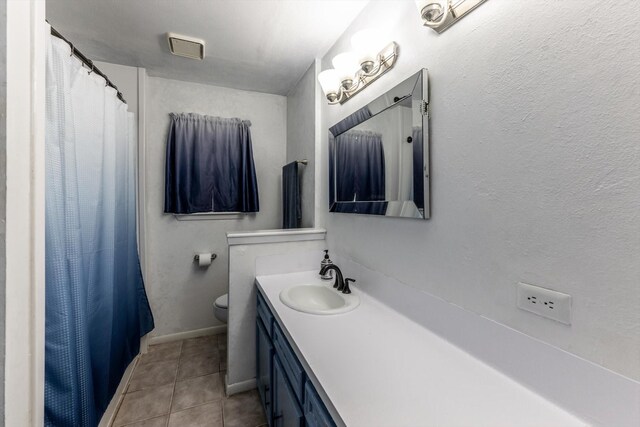 full bath with vanity, tile patterned flooring, toilet, and curtained shower