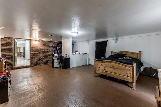 bedroom featuring brick wall