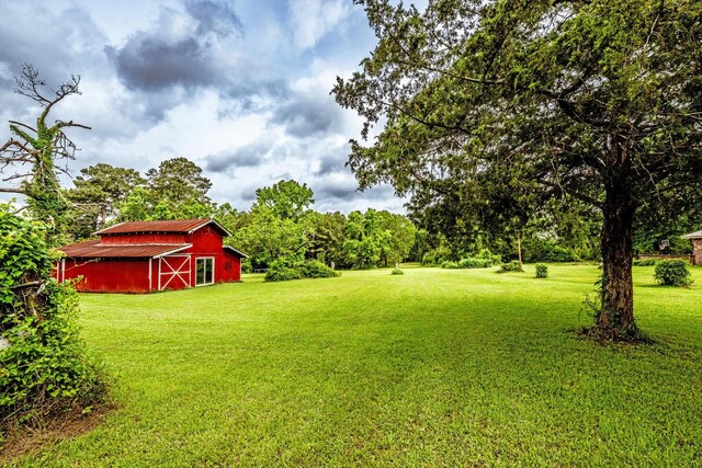 view of yard featuring a barn and an outbuilding