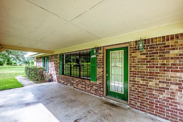 doorway to property with brick siding