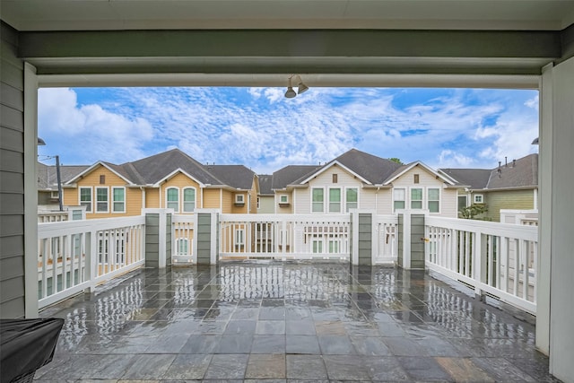 view of patio featuring a balcony and a residential view