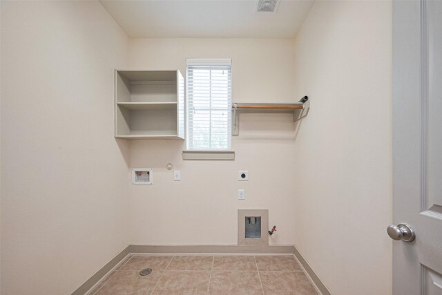 clothes washing area featuring electric dryer hookup, laundry area, baseboards, and gas dryer hookup