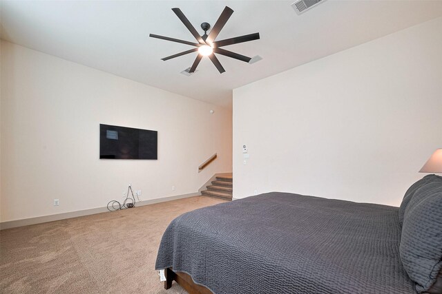 bedroom with baseboards, ceiling fan, light carpet, and visible vents