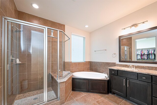 bathroom with vanity, recessed lighting, a bath, tile patterned floors, and a shower stall