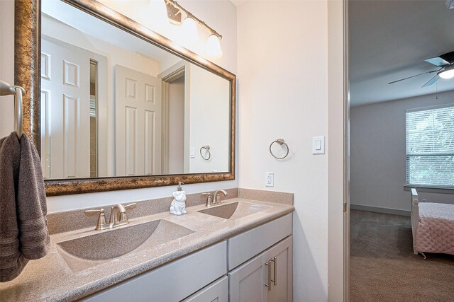 full bathroom featuring double vanity, a sink, and ceiling fan
