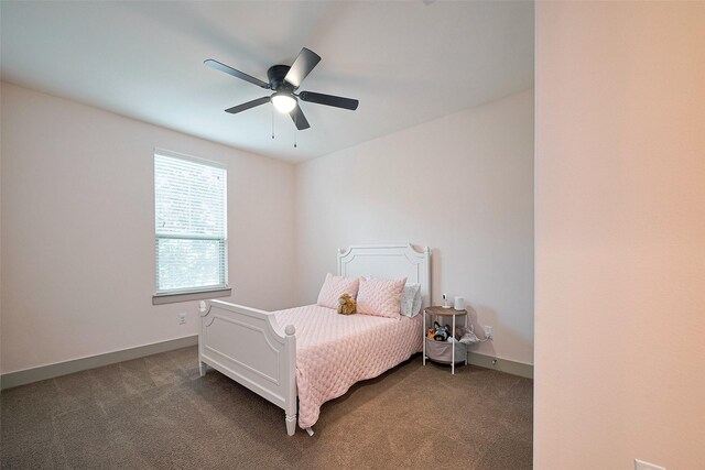 carpeted bedroom featuring baseboards and a ceiling fan