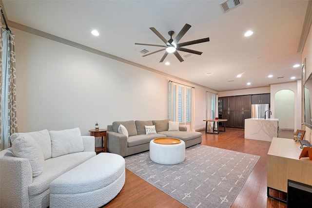 1224 Nelson Falls Ln, Houston, TX 77008 - living area featuring a ceiling fan, arched walkways, wood finished floors, recessed lighting, and crown molding