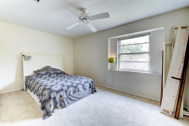 carpeted bedroom with baseboards and ceiling fan