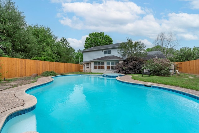 view of swimming pool featuring a fenced backyard and a pool with connected hot tub