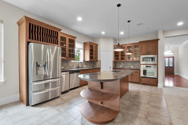 73 La Jolla Cir, Montgomery, TX 77356 - kitchen with a center island, a wealth of natural light, dark countertops, and stainless steel appliances
