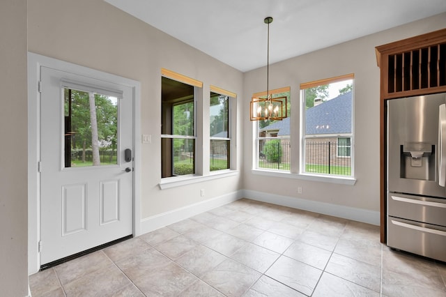 73 La Jolla Cir, Montgomery, TX 77356 - unfurnished dining area featuring baseboards, a chandelier, and light tile patterned floors
