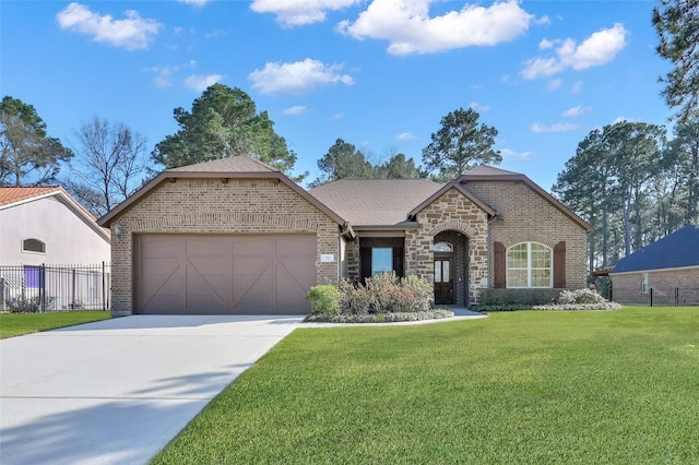 73 La Jolla Cir, Montgomery, TX 77356 - view of front of house featuring a garage, brick siding, fence, a front lawn, and concrete driveway