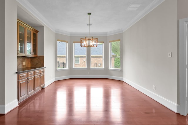 73 La Jolla Cir, Montgomery, TX 77356 - unfurnished dining area featuring a chandelier, a wealth of natural light, and wood finished floors