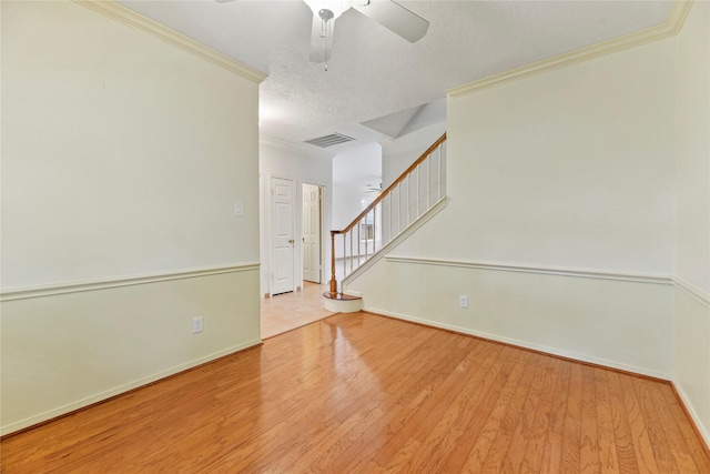 4614 Ringrose Dr, Missouri City, TX 77459 - empty room with crown molding, baseboards, wood finished floors, visible vents, and stairway
