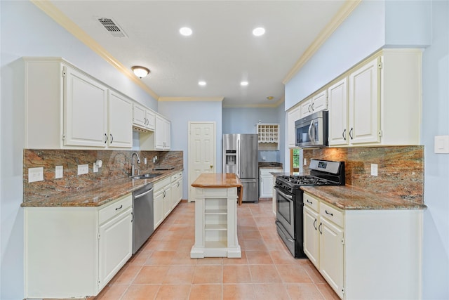 4614 Ringrose Dr, Missouri City, TX 77459 - kitchen featuring light stone counters, a sink, stainless steel appliances, visible vents, and ornamental molding