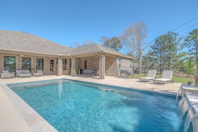 view of swimming pool with fence, a fenced in pool, an outdoor living space, and a patio area