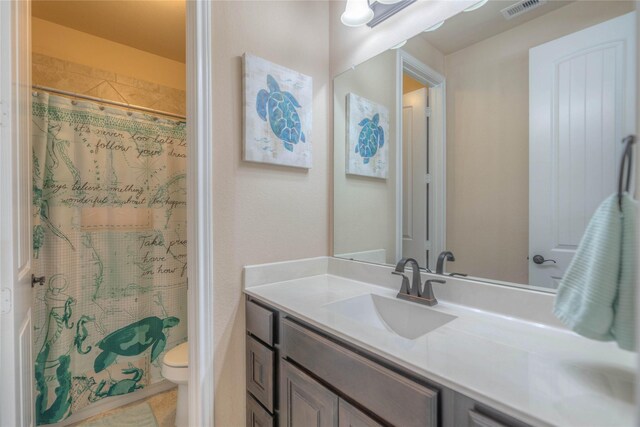 full bathroom with visible vents, a shower with curtain, toilet, and vanity