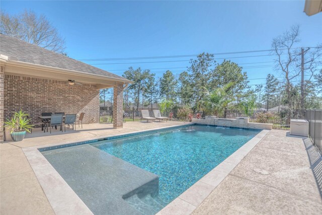 view of swimming pool with a fenced in pool, fence, and a patio area