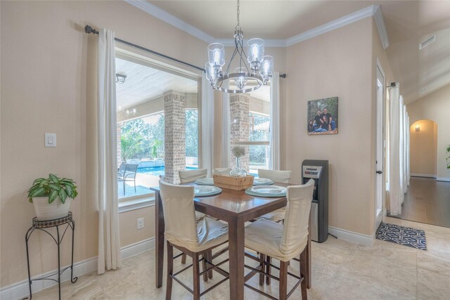 dining room featuring visible vents, crown molding, a chandelier, and a wealth of natural light