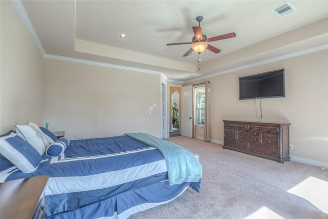 carpeted bedroom with a raised ceiling, baseboards, and visible vents