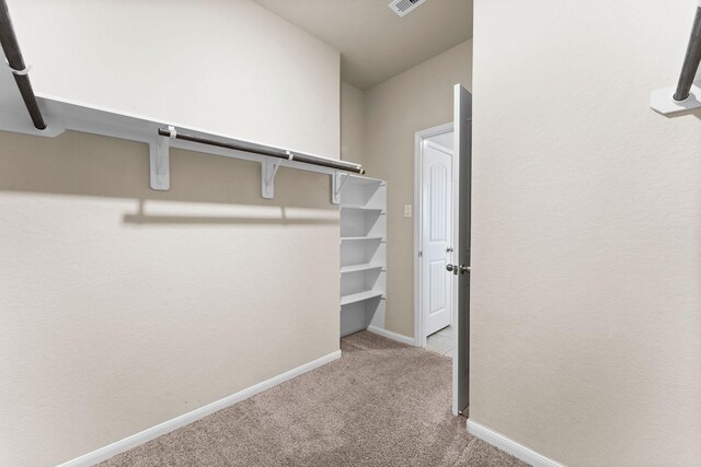 spacious closet with carpet floors and visible vents