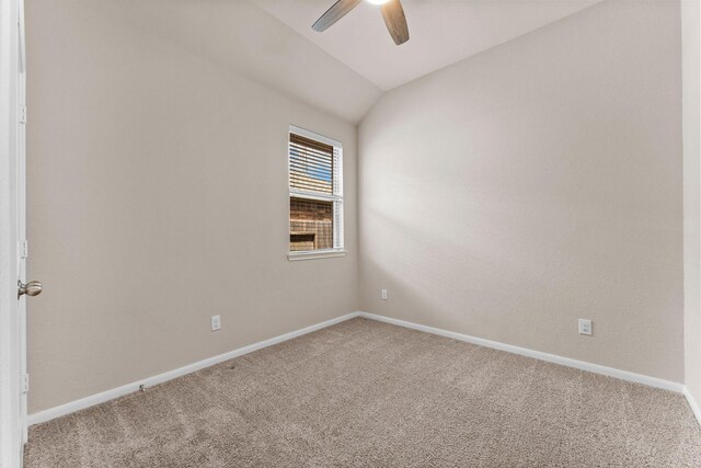 spare room with baseboards, ceiling fan, carpet, and lofted ceiling