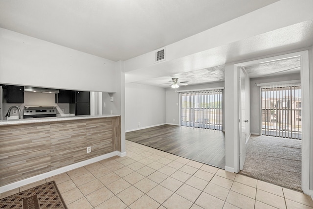 206 Plaza Verde Dr Unit D35, Houston, TX 77038 - kitchen with a sink, stainless steel electric range oven, ceiling fan, and light tile patterned flooring