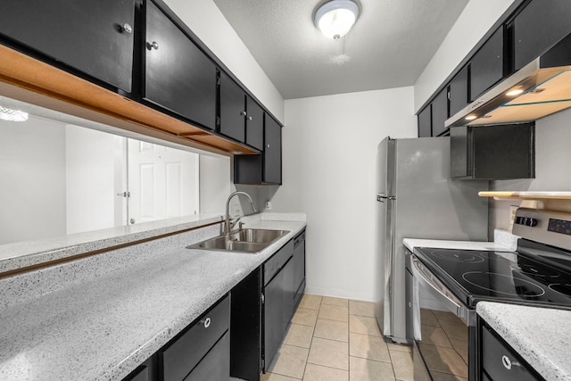 206 Plaza Verde Dr Unit D35, Houston, TX 77038 - kitchen featuring a sink, light countertops, dark cabinets, electric stove, and light tile patterned floors