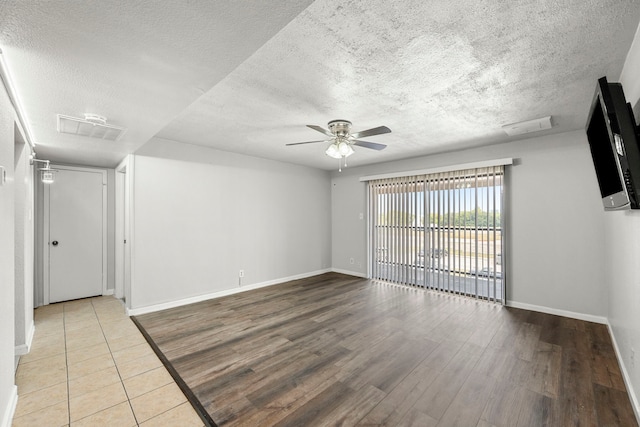 206 Plaza Verde Dr Unit D35, Houston, TX 77038 - empty room with a ceiling fan, a textured ceiling, baseboards, and wood finished floors