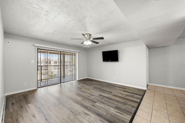 206 Plaza Verde Dr Unit D35, Houston, TX 77038 - spare room featuring baseboards, a ceiling fan, a textured ceiling, and wood finished floors