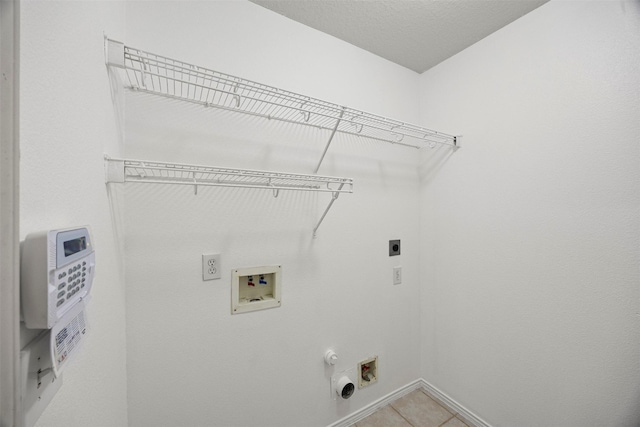 laundry area featuring laundry area, light tile patterned flooring, electric dryer hookup, washer hookup, and hookup for a gas dryer